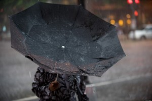 A woman's umbrella is turned inside out